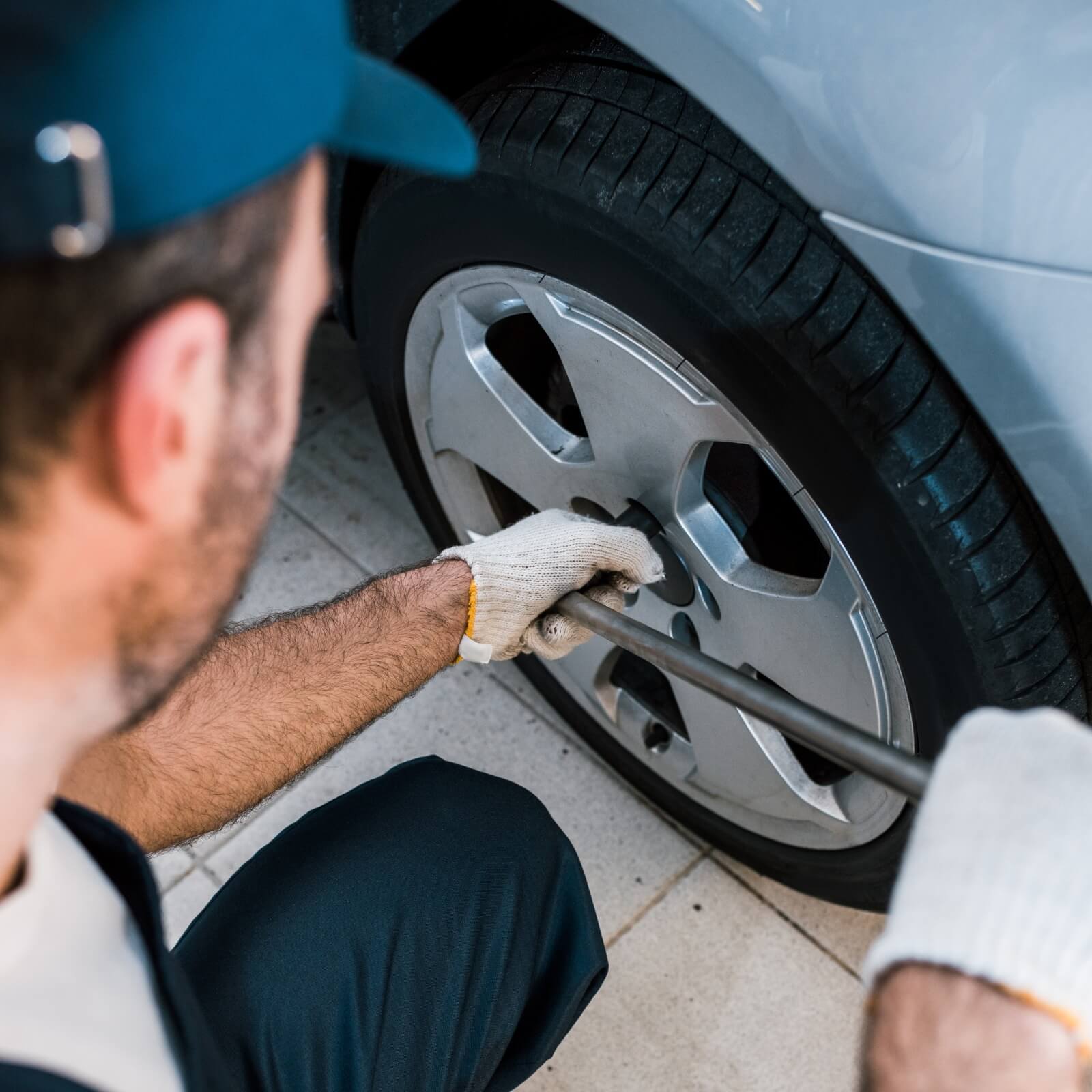 selective focus of car mechanic changing car tire